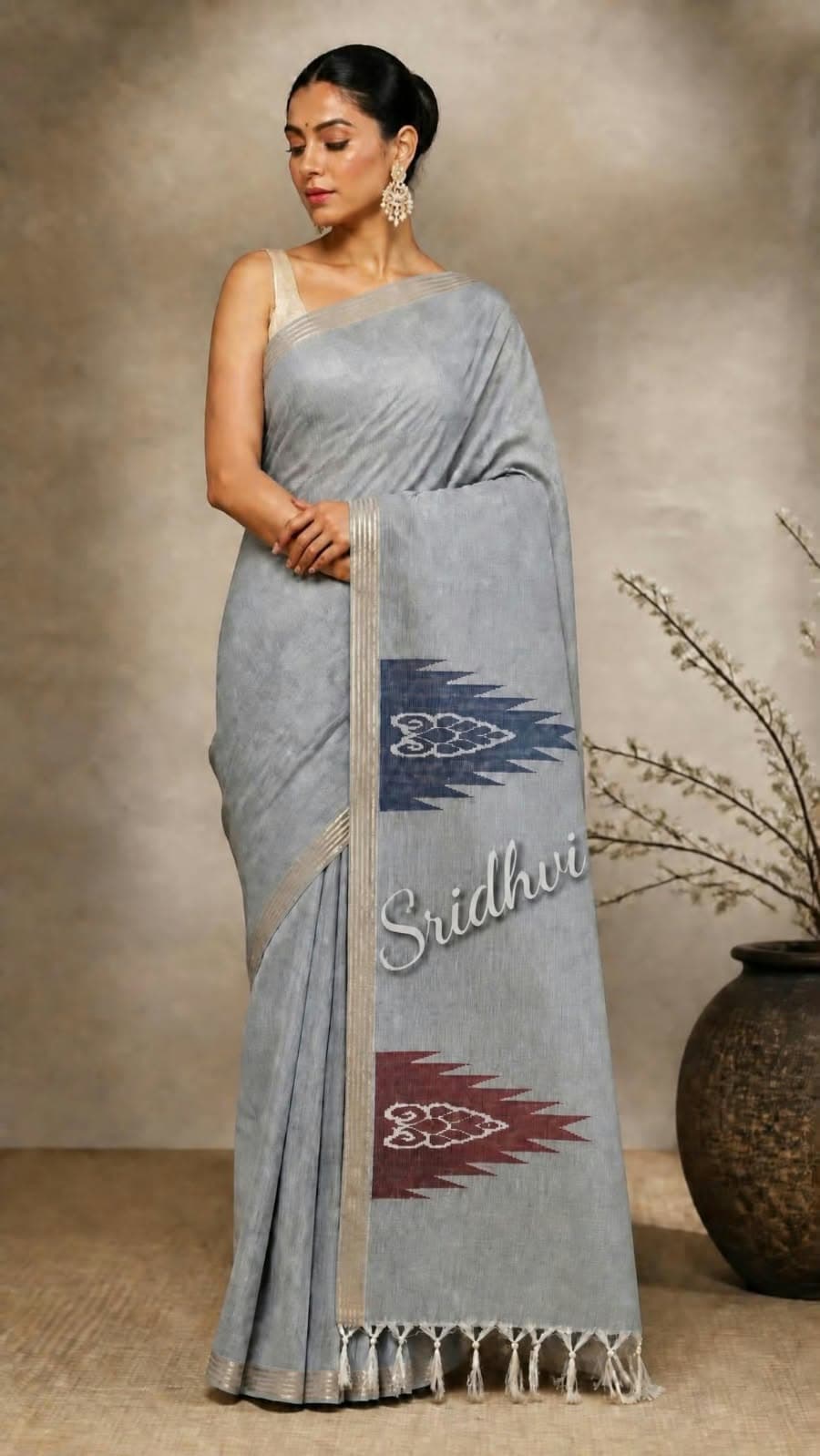Woman in a grey handloom saree with ikat motifs